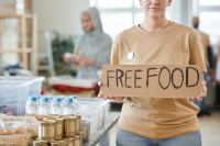 Women with a cardboard sign syaing free food